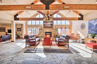 a living room with couches and a fireplace at Walk to Lifts Studio with Hot Tub in Keystone! in Keystone