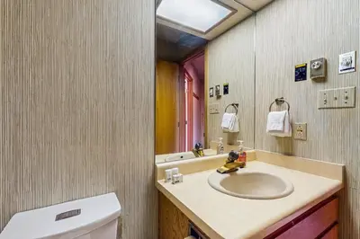 a bathroom with a sink and a toilet and a mirror at Lookout Lounge in Fraser