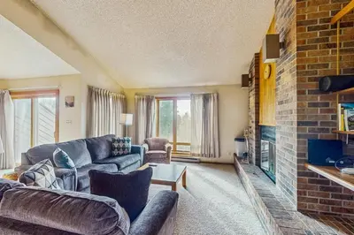 a living room with couches and a fireplace at Lookout Lounge in Fraser