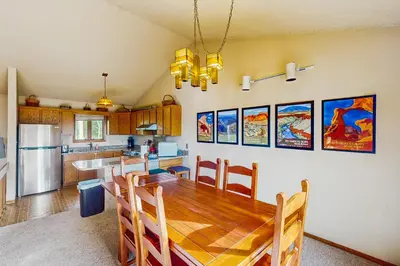 a kitchen with a wooden table and a dining room at Lookout Lounge in Fraser