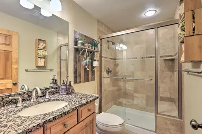 a bathroom with a shower and a sink and a toilet at Black Hawk Mountain Cabin about 4 Mi to Casinos! in Black Hawk