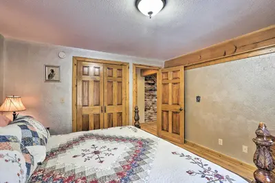 a bedroom with a bed in a room with wooden walls at Black Hawk Mountain Cabin about 4 Mi to Casinos! in Black Hawk