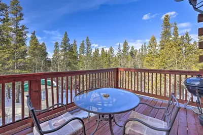 a patio with a table and chairs on a deck at Black Hawk Mountain Cabin about 4 Mi to Casinos! in Black Hawk