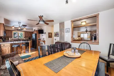 a dining room and kitchen with a table and chairs at Bear House -- EV #3073 home in Estes Park