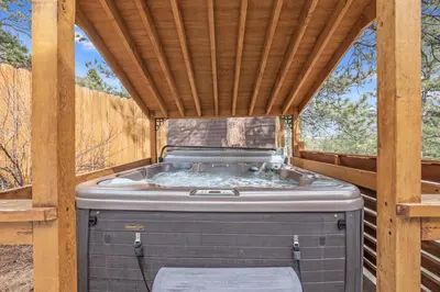 a hot tub in a gazebo with a wooden roof at Bear House -- EV #3073 home in Estes Park
