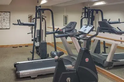 a gym with several tread machines in a room at 2 Blocks to Light Rail Denver Unit with Kitchenette in Greenwood Village
