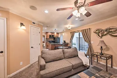 a living room with a couch and a ceiling fan at Condo with Patio and Pool Access in Greenwood Village! in Greenwood Village