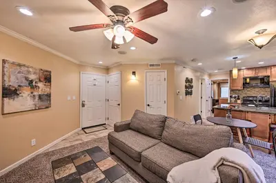 a living room with a couch and a ceiling fan at Condo with Patio and Pool Access in Greenwood Village! in Greenwood Village