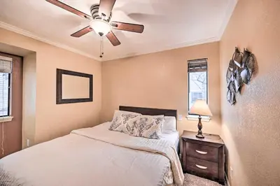 a bedroom with a bed and a ceiling fan at Condo with Patio and Pool Access in Greenwood Village! in Greenwood Village