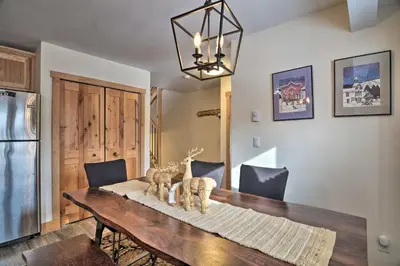 a dining room with a table and a refrigerator at Cozy Mountain Getaway with Ski Shuttle Access! in Fraser