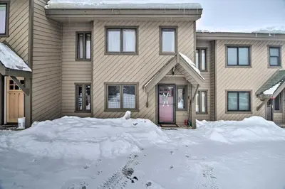 a house with a pile of snow in front of it at Cozy Mountain Getaway with Ski Shuttle Access! in Fraser