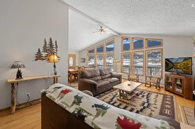 a living room with a couch and a table at Lily Mountain Lodge - Amazing Mountains Views, Private Hot Tub, Great Location in Estes Park