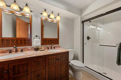 a bathroom with two sinks and a shower at Lily Mountain Lodge - Amazing Mountains Views, Private Hot Tub, Great Location in Estes Park