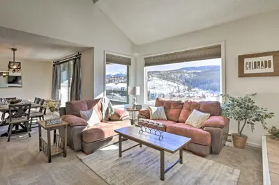 a living room with a couch and a table at Walkable Winter Park Condo about 4 Mi to Slopes! in Winter Park