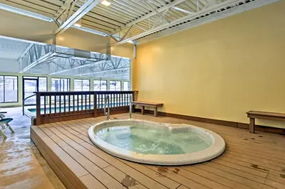 a large jacuzzi tub in the middle of a room at Walkable Winter Park Condo about 4 Mi to Slopes! in Winter Park