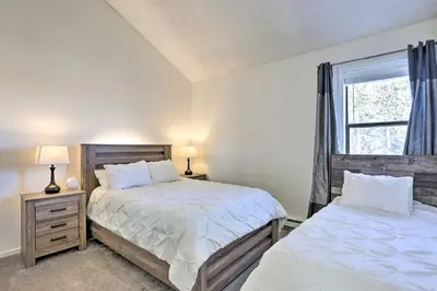 a bedroom with two beds and a window at Walkable Winter Park Condo about 4 Mi to Slopes! in Winter Park