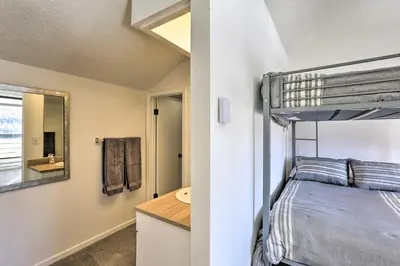 a bedroom with a bunk bed and a sink at Walkable Winter Park Condo about 4 Mi to Slopes! in Winter Park