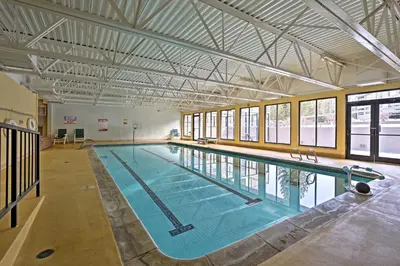 a large swimming pool in a large building at Walkable Winter Park Condo about 4 Mi to Slopes! in Winter Park
