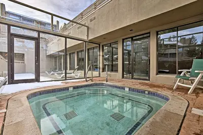 a swimming pool in the middle of a house at Walkable Winter Park Condo about 4 Mi to Slopes! in Winter Park