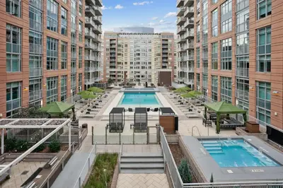 an apartment patio with a pool and buildings at Sentral Union Station in Denver