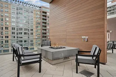 a patio with chairs and a fire pit on a building at Sentral Union Station in Denver