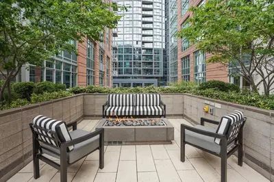 a patio with two chairs and a bench and a fire pit at Sentral Union Station in Denver
