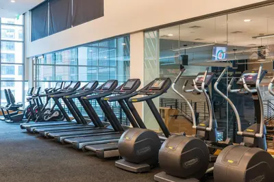 a row of exercise bikes lined up in a gym at Sentral Union Station in Denver
