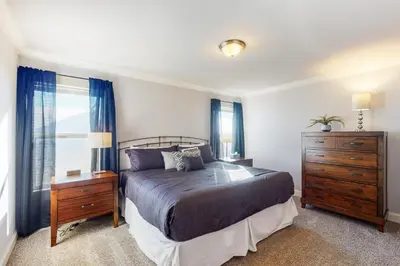 a bedroom with a bed and a dresser and a window at Quail Nest on Quail Drive in Fraser