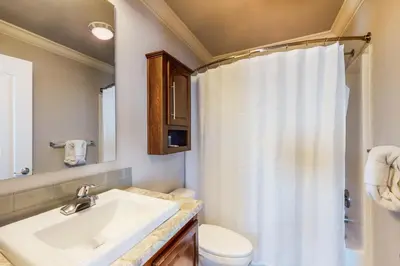 a bathroom with a sink and a toilet and a shower at Quail Nest on Quail Drive in Fraser