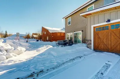 a driveway covered in snow next to a house at Quail Nest on Quail Drive in Fraser