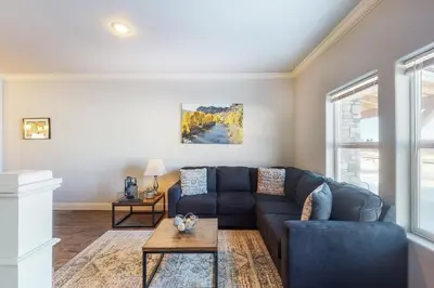 a living room with a blue couch and a table at Quail Nest on Quail Drive in Fraser