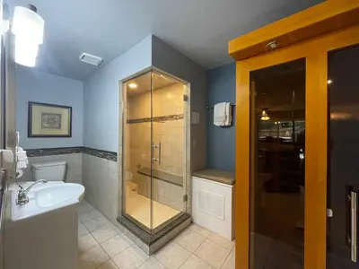 a bathroom with a shower and a sink at Couples Retreat with Hot Tub, Sauna and Steam Room in Fort Collins
