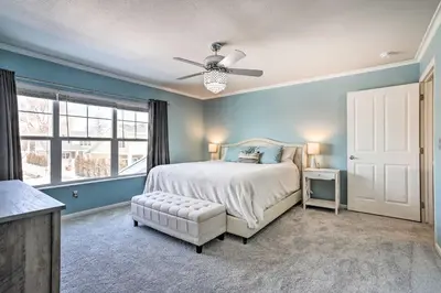 a bedroom with a bed and a ceiling fan at Modern-Chic Englewood Home with Yard and Office! in Englewood