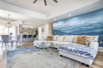 a living room with a couch and a table at Modern-Chic Englewood Home with Yard and Office! in Englewood