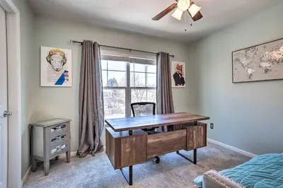 a home office with a desk and a window at Modern-Chic Englewood Home with Yard and Office! in Englewood