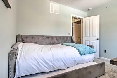 a bed with a silver headboard in a bedroom at Modern-Chic Englewood Home with Yard and Office! in Englewood