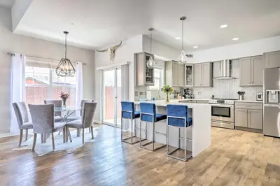 a kitchen with a table and chairs and a counter top at Modern-Chic Englewood Home with Yard and Office! in Englewood