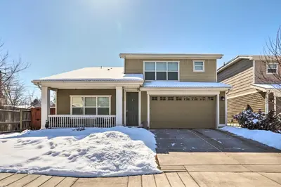 a house with snow in front of it at Modern-Chic Englewood Home with Yard and Office! in Englewood