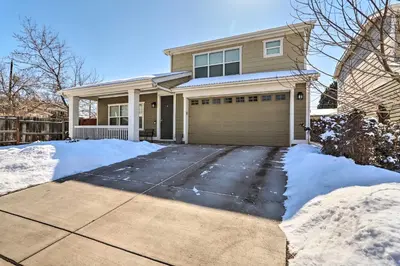 a house with a garage in the snow at Modern-Chic Englewood Home with Yard and Office! in Englewood