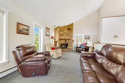 a living room with a leather couch and chairs at Misty Meadow in Fraser