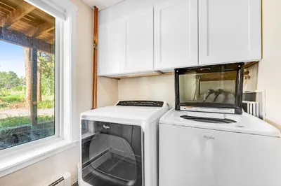 a washer and dryer in a kitchen with a window at Misty Meadow in Fraser