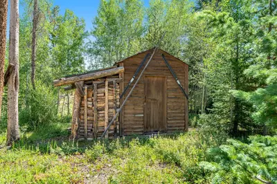 a wooden out house in the middle of a forest at Misty Meadow in Fraser