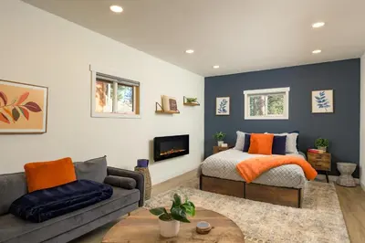 a living room with a bed and a couch at The Evergreen Castle in Evergreen
