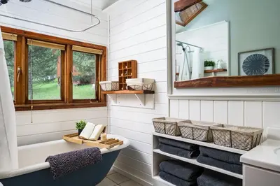 a bathroom with a tub and a sink at The Evergreen Castle in Evergreen