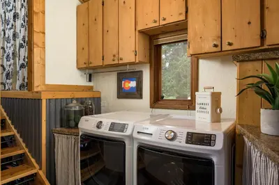 a kitchen with a white stove top oven next to a window at The Evergreen Castle in Evergreen