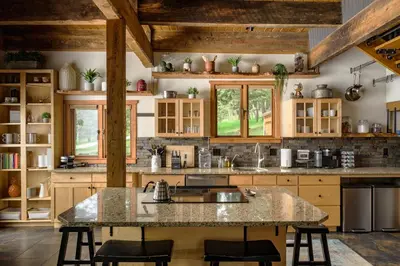 a kitchen with wooden cabinets and a large island at The Evergreen Castle in Evergreen