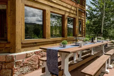 a picnic table on the side of a building with windows at The Evergreen Castle in Evergreen