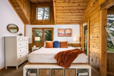 a bedroom with a bed and a wooden ceiling at The Evergreen Castle in Evergreen