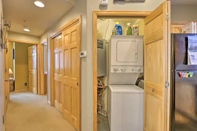 a laundry room with a washer and dryer and a refrigerator at Mountainside Grand Lake Condo with Patio! in Grand Lake