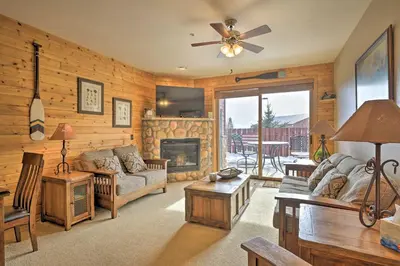 a living room with a couch and a fireplace at Mountainside Grand Lake Condo with Patio! in Grand Lake